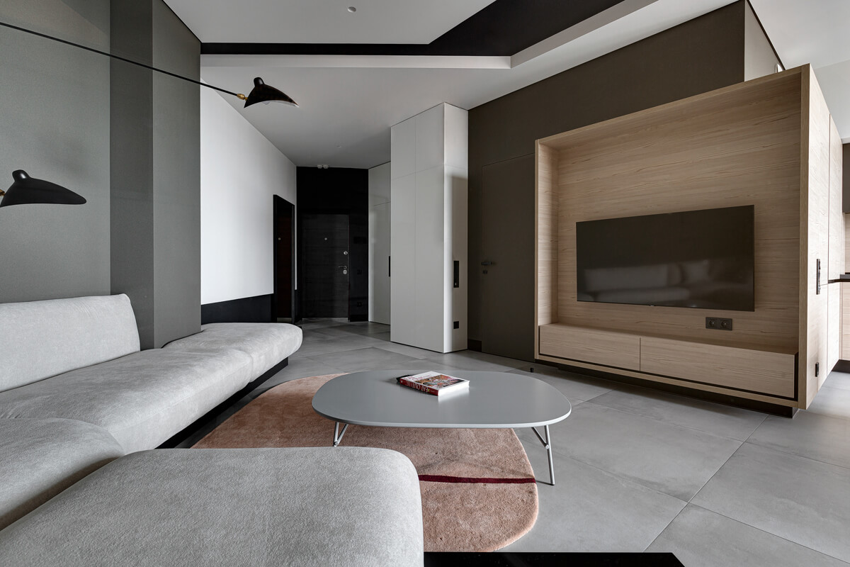 Дизайн вітальні в сучасному стилі з використанням натурального дерева і текстилю.