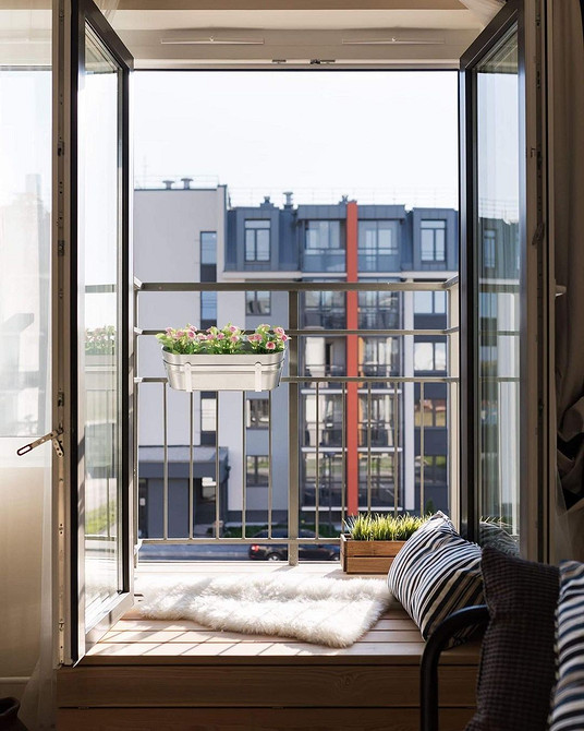 Облаштування підвіконня в затишний диван з використанням м'яких та приємних на дотик тканин.