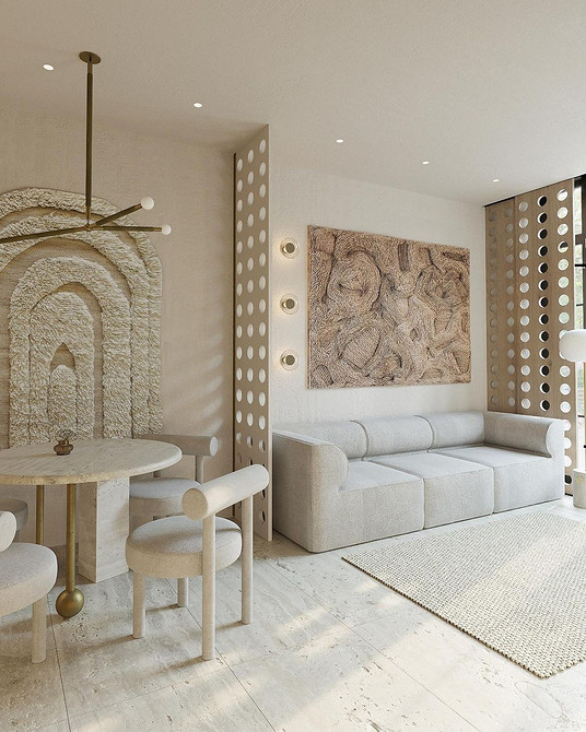 Великий кутовий бежевий диван з подушками у вітальні для сімейного затишку.