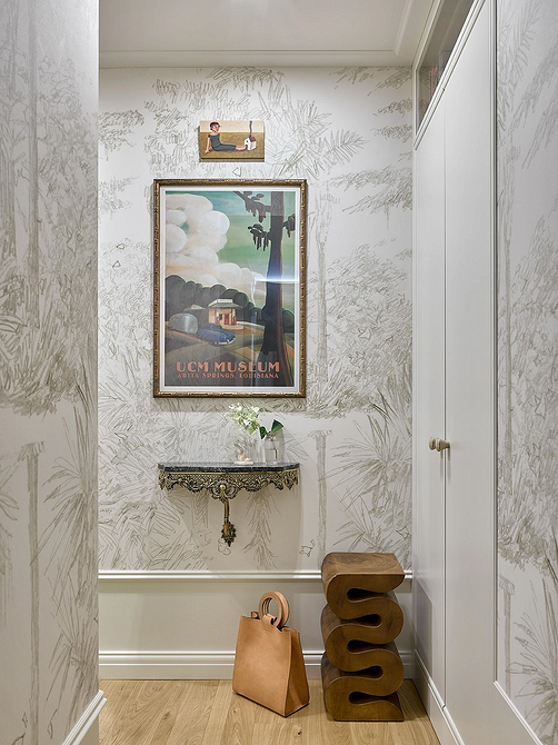 Вітальня з каміном, диваном та кріслами різних стилів, об'єднаних загальною колірною гамою.