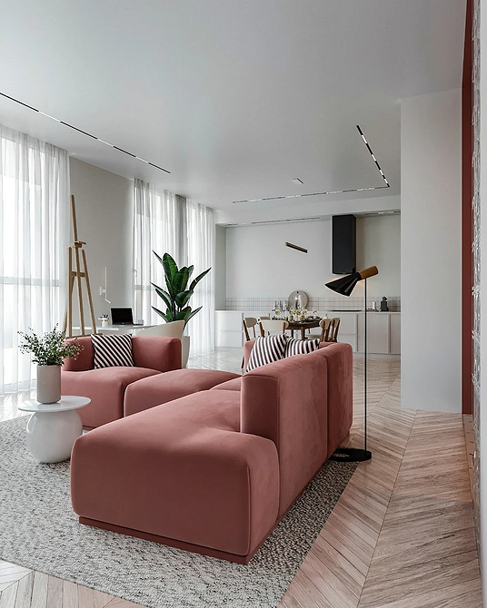 Монохромний сірий диван з подушками різних текстур у сучасній вітальні.