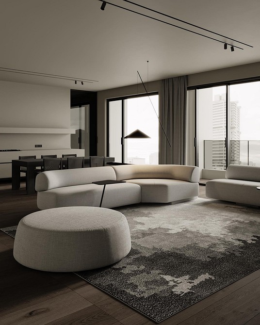 Вітальня з монохромним сірим диваном та великим вікном для природного освітлення.