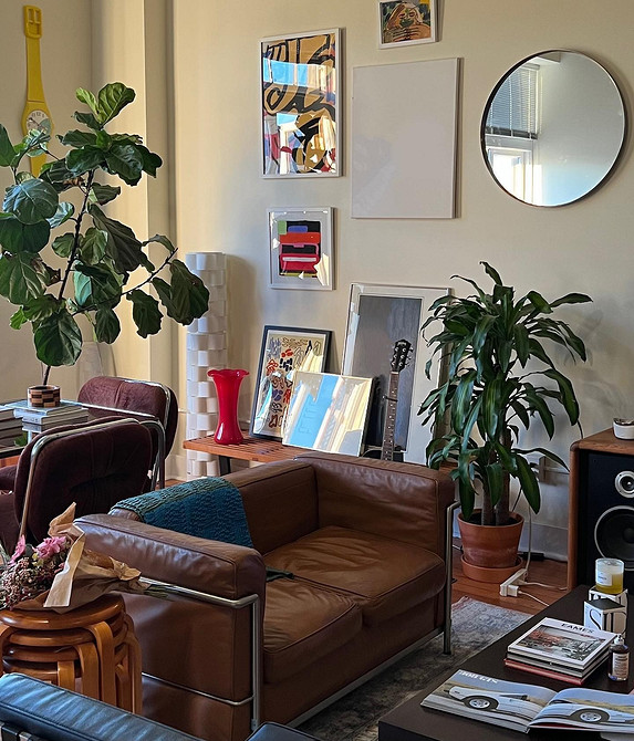 Кутовий шкіряний диван у вітальні з панорамними вікнами, сучасний дизайн.