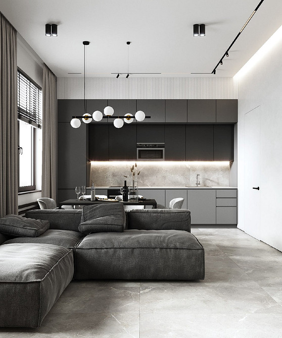 Сучасна вітальня з сірими меблями: килим, диван, журнальний столик і декоративні елементи.