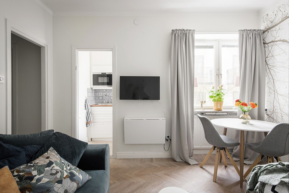 Універсальний дизайн з сірими меблями: компактна вітальня з сірим диваном та книжковою шафою.