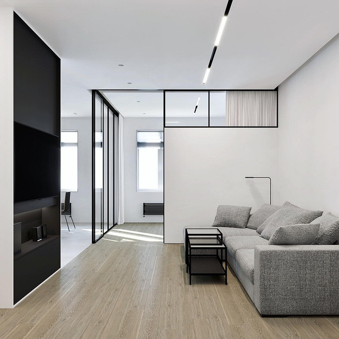 Сірий диван з різнокольоровими подушками в інтер'єрі сучасної вітальні