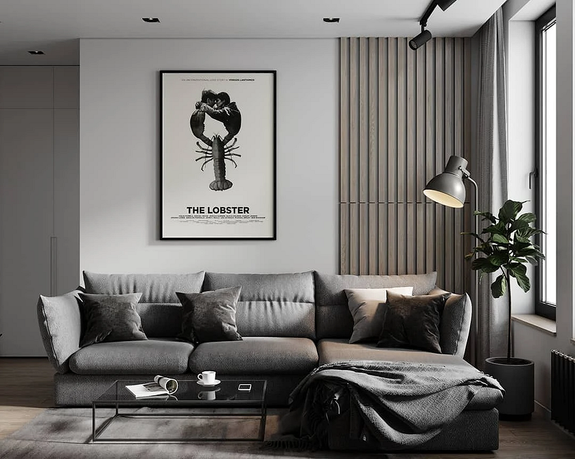 Стильний сірий диван у вітальні з декоративними подушками та пледом, затишний куточок.