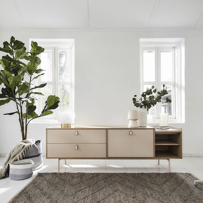 Підвісна тумба під телевізор у світлій вітальні з мінімалістичним дизайном.