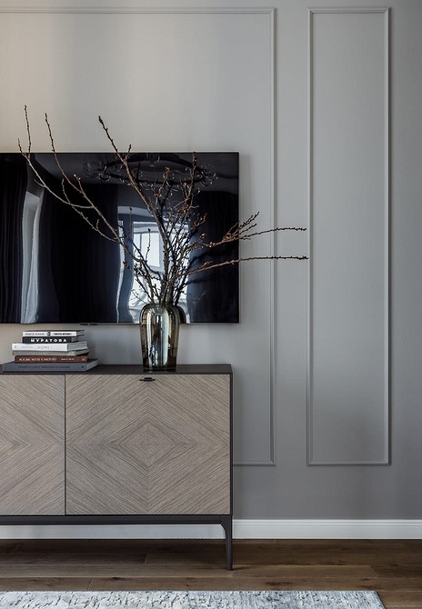 Біла тумба під телевізор з глянцевими фасадами для сучасної та світлої вітальні.