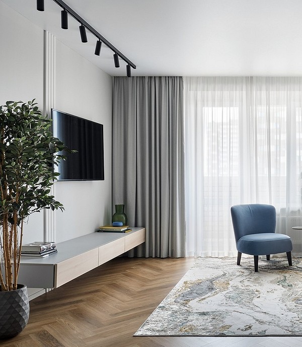 Сучасна тумба під телевізор у вітальні з мінімалістичним дизайном.