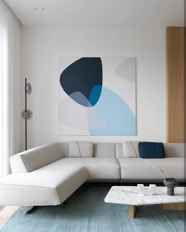 Стильний кутовий диван у сучасному інтер'єрі вітальні, м'які подушки додають затишку.