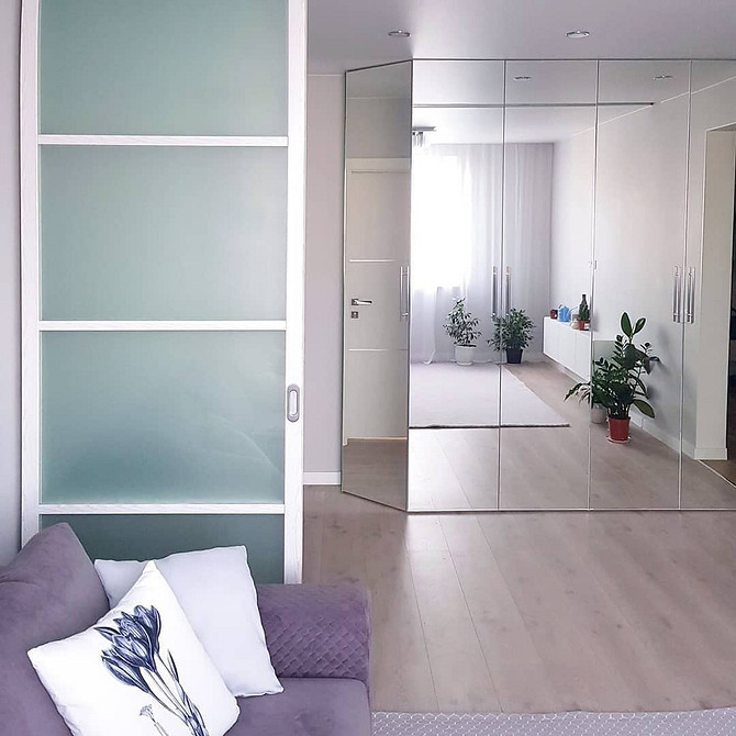 Кутова дзеркальна шафа у вітальні: ергономічне рішення для невеликих приміщень.