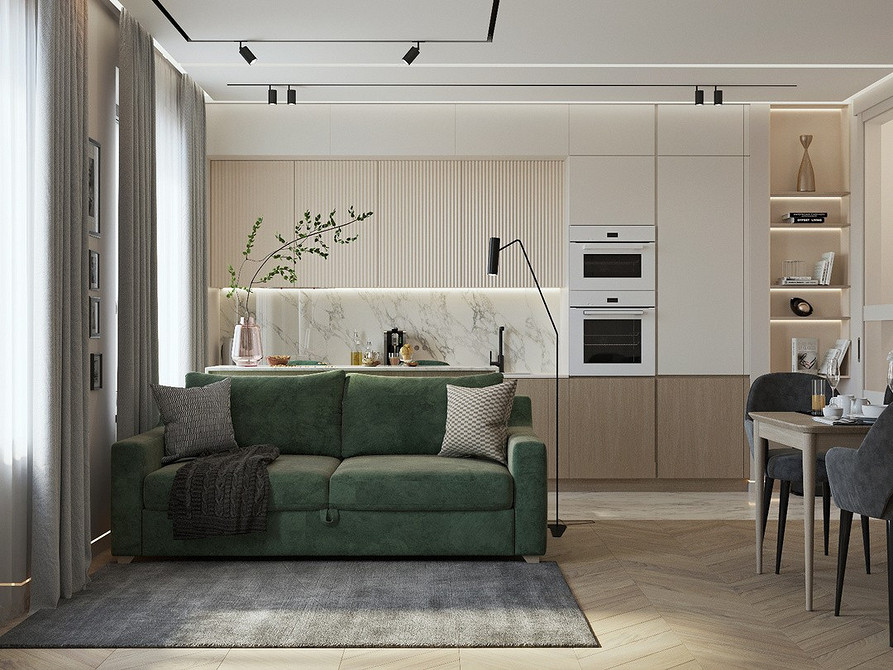 Дизайн маленької квартири з компактним зеленим диваном та світлими меблями