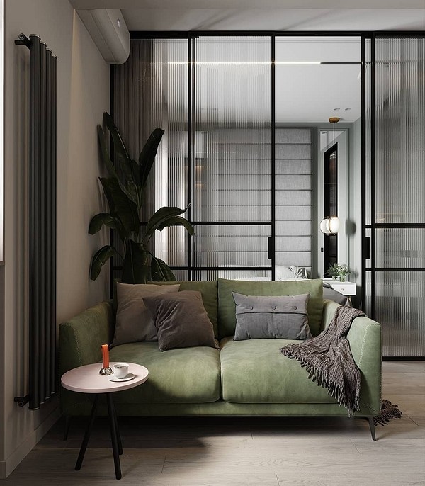 Зелений диван в інтер'єрі вітальні з дерев'яними елементами, стиль 2026 року