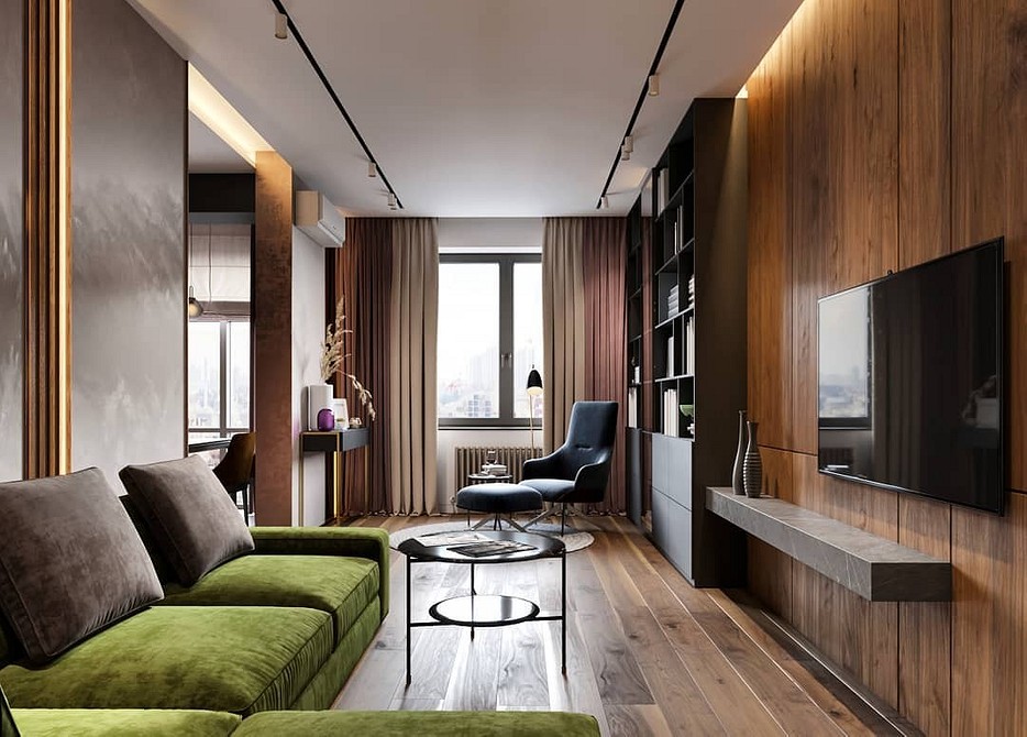 Смарагдовий диван в інтер'єрі з дерев'яним столиком та рослинами, тренди 2026