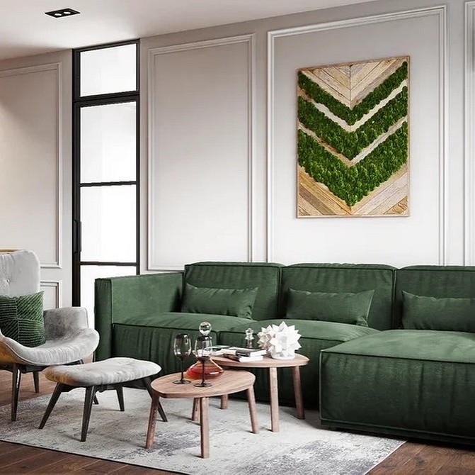 Світла вітальня з мінімалістичним зеленим диваном, білим килимом та чорними акцентами.