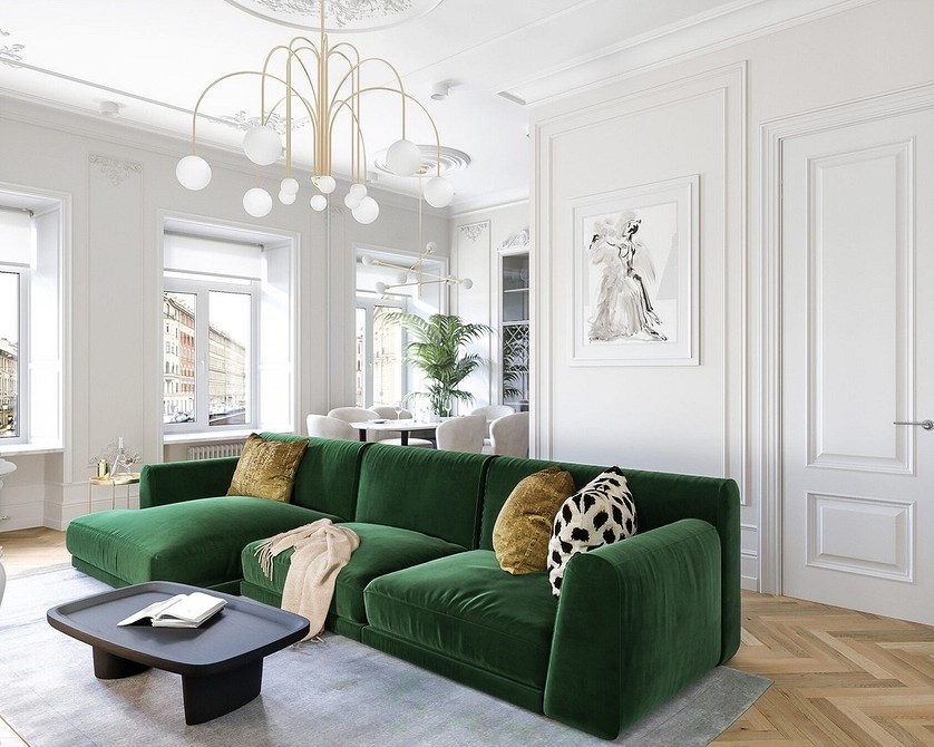 Зелений диван з велюровою оббивкою в інтер'єрі з темними стінами та каміном.