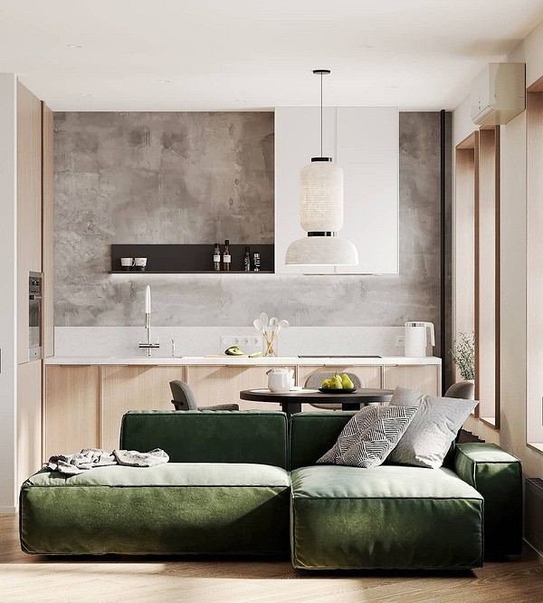 Оливковий диван в мінімалістичній квартирі з сірими стінами та рослинами