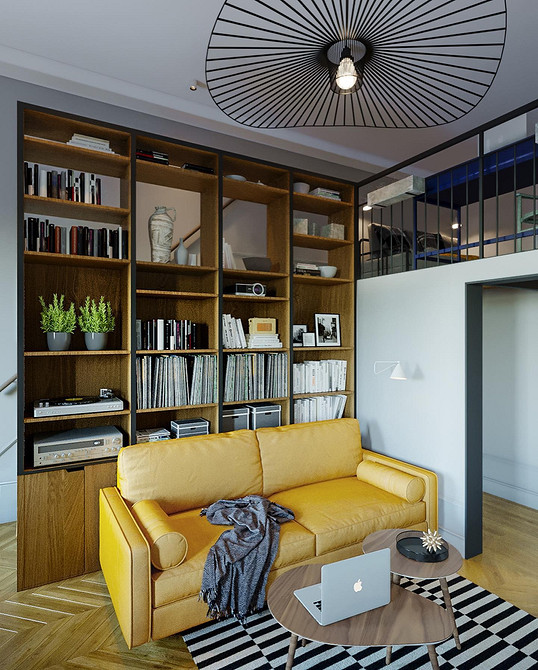 Невеликий жовтий диванчик в мінімалістичній вітальні з каміном і дерев'яною підлогою.